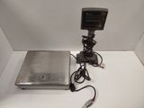 a laptop computer sitting on a table with a charger attached to it