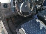 a small car with a steering wheel and a blue seat cover