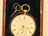 a box with a clock and a pair of scissors in it