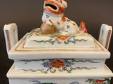 a porcelain box with a dog on it