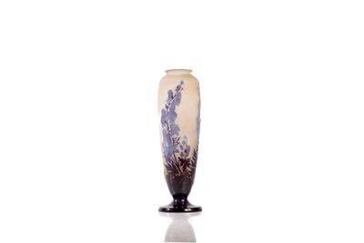 a vase that is sitting on a stand on a white surface