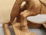 a wooden rocking horse that is sitting on a table
