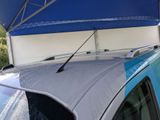 a car that is parked under a blue awning