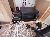a black printer sitting on top of a wooden table
