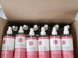 six flacons de gel hydroalcoolique dans une boîte en carton posée sur une table