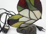 a picture of a stained glass butterfly lamp on a rock
