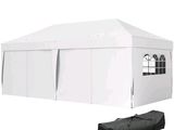 a white tent with a black bag on top of it