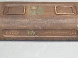 an old metal box that is sitting on top of a table