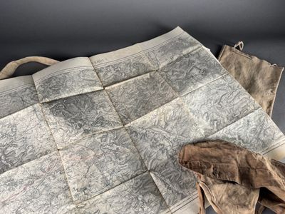a piece of cloth with a map on it and a pair of gloves next to it