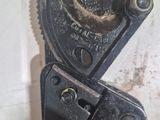 a close up of a pipe cutter on a table