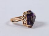 a close up of a gold ring with an amethorate stone