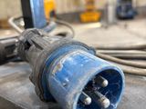 a close up of a blue electrical plug on a table
