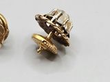 pair of gold tone stud earrings with a white background