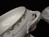 a white bowl with a green and white design on it