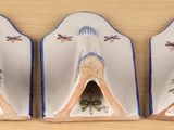 pair of decorative ceramic bookends with birds and dragonflies on them