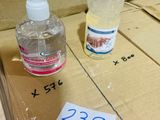 two bottles of hand sanitizer sitting on top of a cardboard box