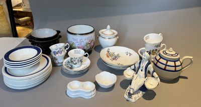 a table with a lot of dishes and cups on it