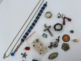 a white plate with a bunch of jewelry on it
