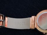 a close up of a wrist watch on a black surface