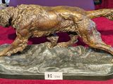 statue of a golden retriever on a rock on a red carpet