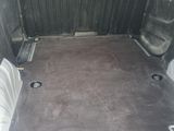 the interior of a van with the door open and the seat folded down