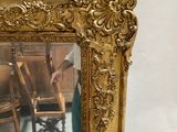 a man standing in front of a mirror with a chair in front of him