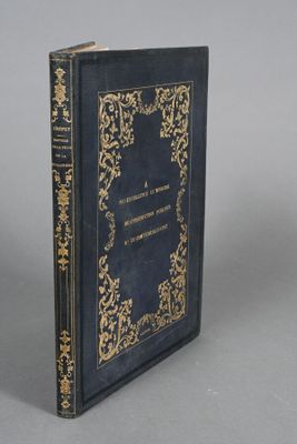 a blue book with gold trim sitting on top of a table