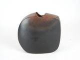 a black and brown vase on a white background