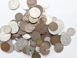 a pile of coins sitting on a white surface