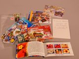 a lot of books and postcards on the table