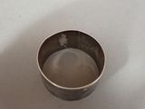 a metal cup that is sitting on a table