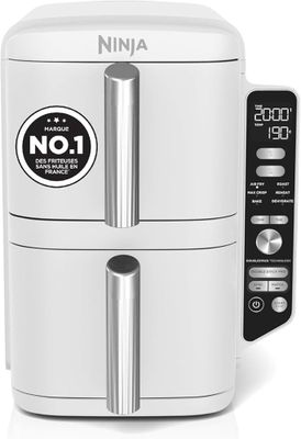 a close up of a white air fryer sitting on top of a counter