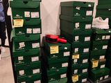 several green boxes are stacked on top of each other in a room
