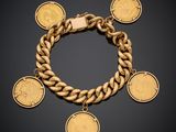 a gold bracelet with five different coins on it