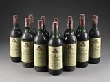 six bottles of wine are lined up in a row on a table
