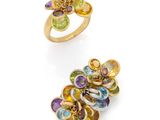 a pair of rings with multicolored stones and gold