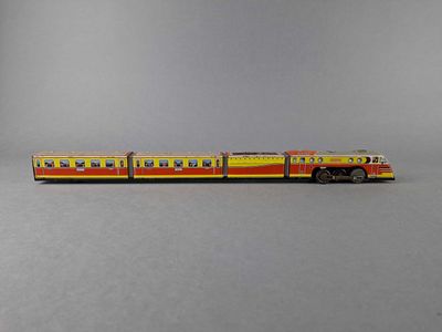 a toy train that is sitting on a gray surface
