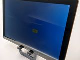 a tablet computer with a blue screen sitting on a table