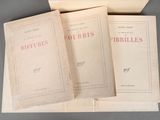 three books sitting on top of each other on a table