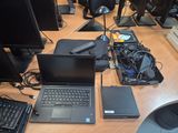 a laptop computer sitting on a desk next to a monitor and keyboard