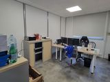 a room with a lot of desks and chairs in it
