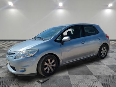 the silver car is parked on a checkered floor in the garage