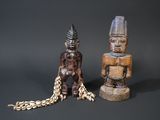 two figurines sitting next to each other on a table
