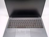 a silver laptop with a black keyboard on a white surface