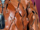 an image of a mannequin wearing a brown leather jacket