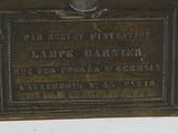 a plaque on the side of a building with a clock on it