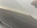 the front bumper of a car with a dent on it