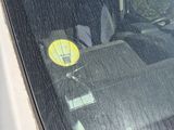 a sticker on the windshield of a car with a sticker on it