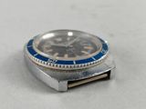 a silver watch with a blue face on a white surface