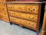 a dresser and a chest of drawers in a room